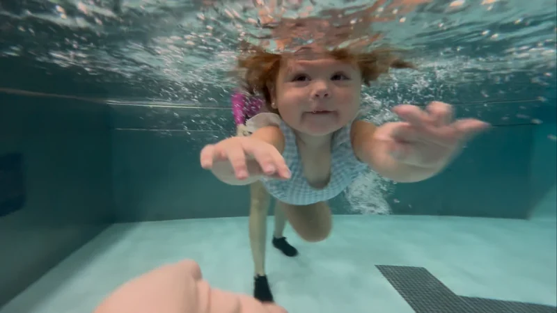 Child swimming independently underwater